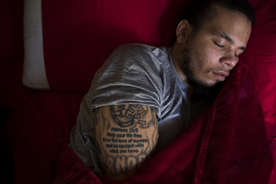 caption: DaShawn Horne rests in his new bedroom on the first floor shortly after arriving home from spending 103 nights at Harborview Medical Center, on Thursday, May 3, 2018, at his home in Auburn. 