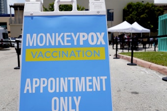 caption: A sign for monkeypox vaccinations is shown at a vaccination site in Miami Beach, Fla.