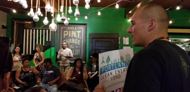 caption: <p>A supporter of Portland Clean Energy Fund speaks to the crowd at Brown Hope's Reparation Power Hour.&nbsp;</p>