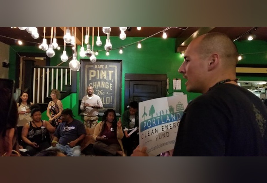 caption: <p>A supporter of Portland Clean Energy Fund speaks to the crowd at Brown Hope's Reparation Power Hour.&nbsp;</p>
