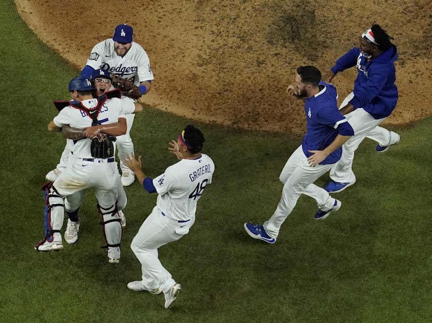 caption: Los Angeles Dodgers celebrate after defeating the Tampa Bay Rays 3-1 to win the 2020 World Series in Game 6 in Arlington, Texas.