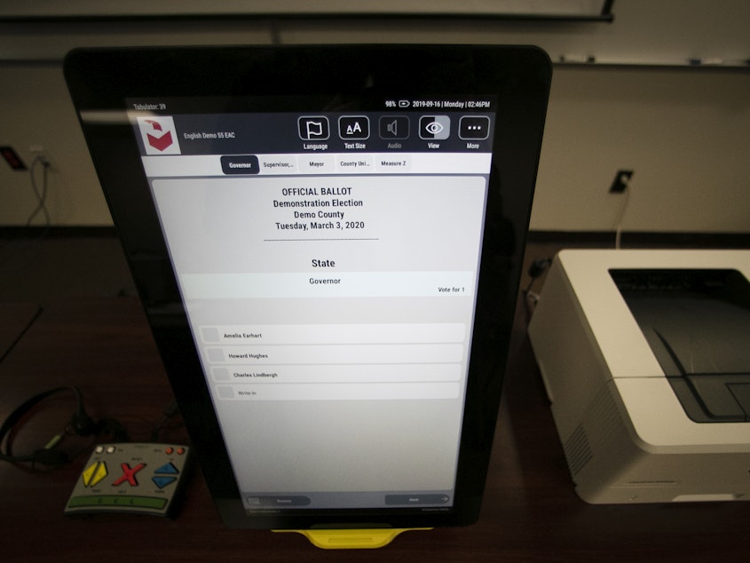 caption: A sample ballot is shown using the Dominion Voting system, the machines that have been under attack by former President Trump following the 2020 elections.