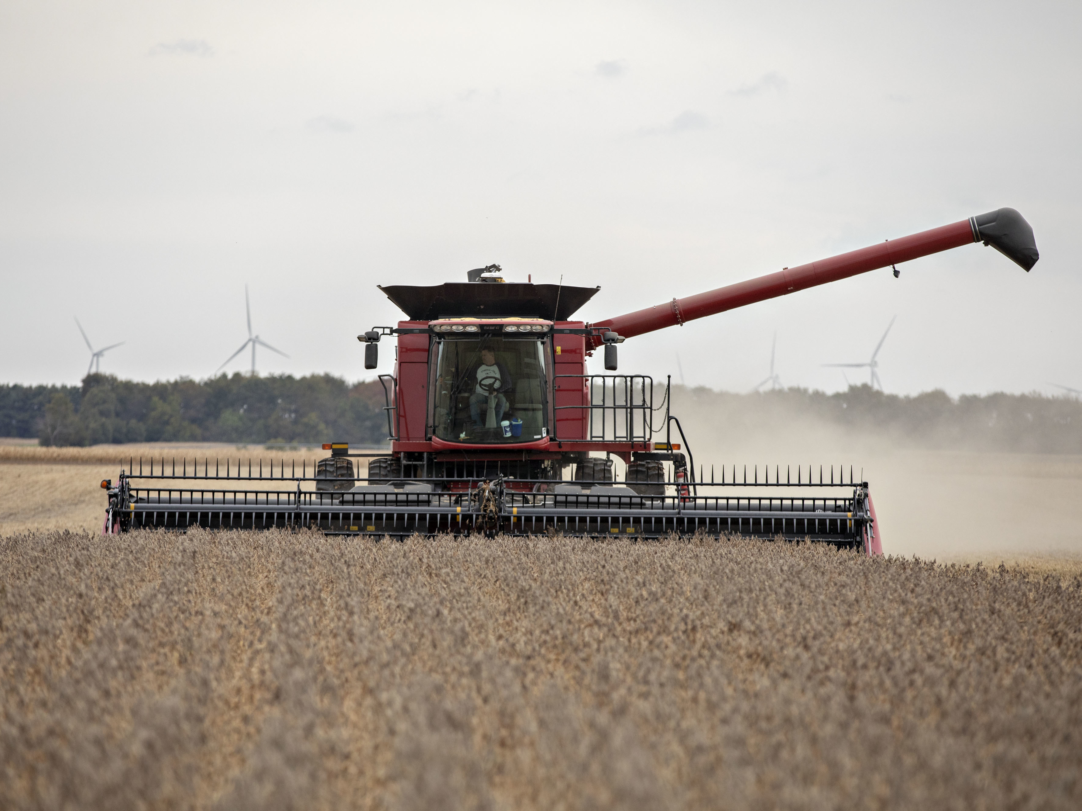 caption: A farmer operates a combine to harvest soybeans in Wyanet, Ill. Farmers got more than $22 billion in government payments in 2019. It's the highest level of farm subsidies in 14 years.
