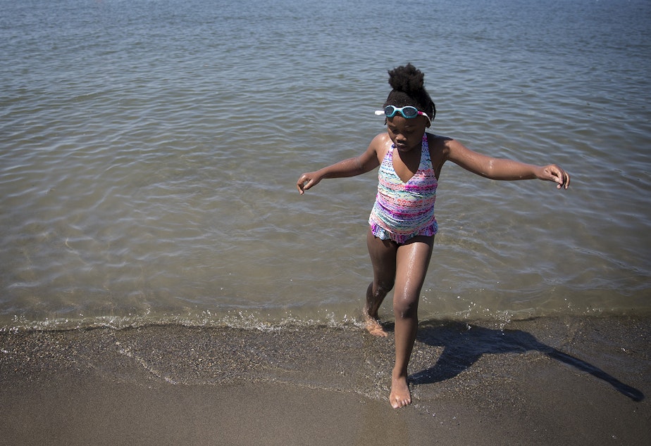 caption: Mariah Hicks, 7, plays in the water during her birthday party on Saturday, July 1, 2017, at Gene Coulon Memorial Beach Park in Renton, Washington. 