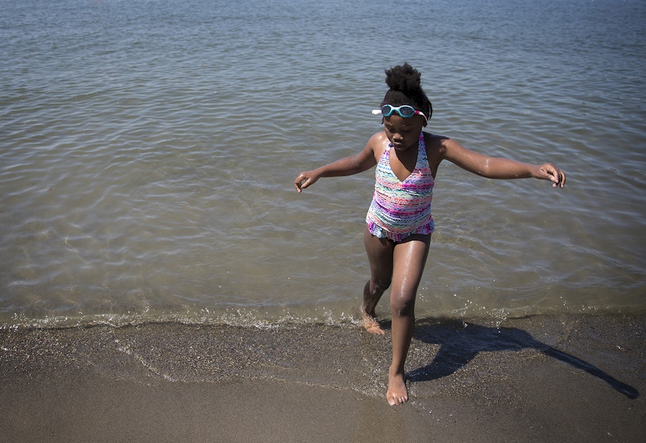 caption: Mariah Hicks, 7, plays in the water during her birthday party on Saturday, July 1, 2017, at Gene Coulon Memorial Beach Park in Renton, Washington.