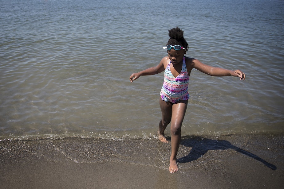 caption: Mariah Hicks, 7, plays in the water during her birthday party on Saturday, July 1, 2017, at Gene Coulon Memorial Beach Park in Renton, Washington. 