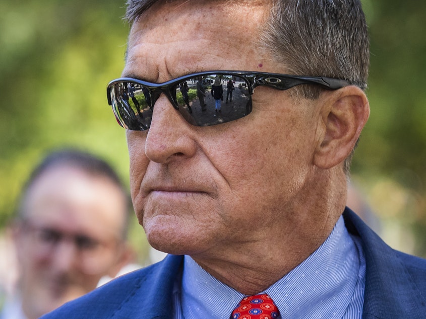 caption: Michael Flynn, President Trump's former national security adviser, leaves federal court following a status conference with U.S. District Judge Emmet Sullivan in Washington in September.