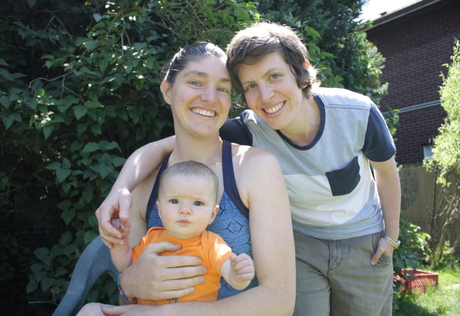 caption: Seattle moms Sarah Weigle and Julia Crouch and their daughter Maya. Although married in Washington state, Crouch chose to adopt their daughter to protect her status as a parent across the U.S.