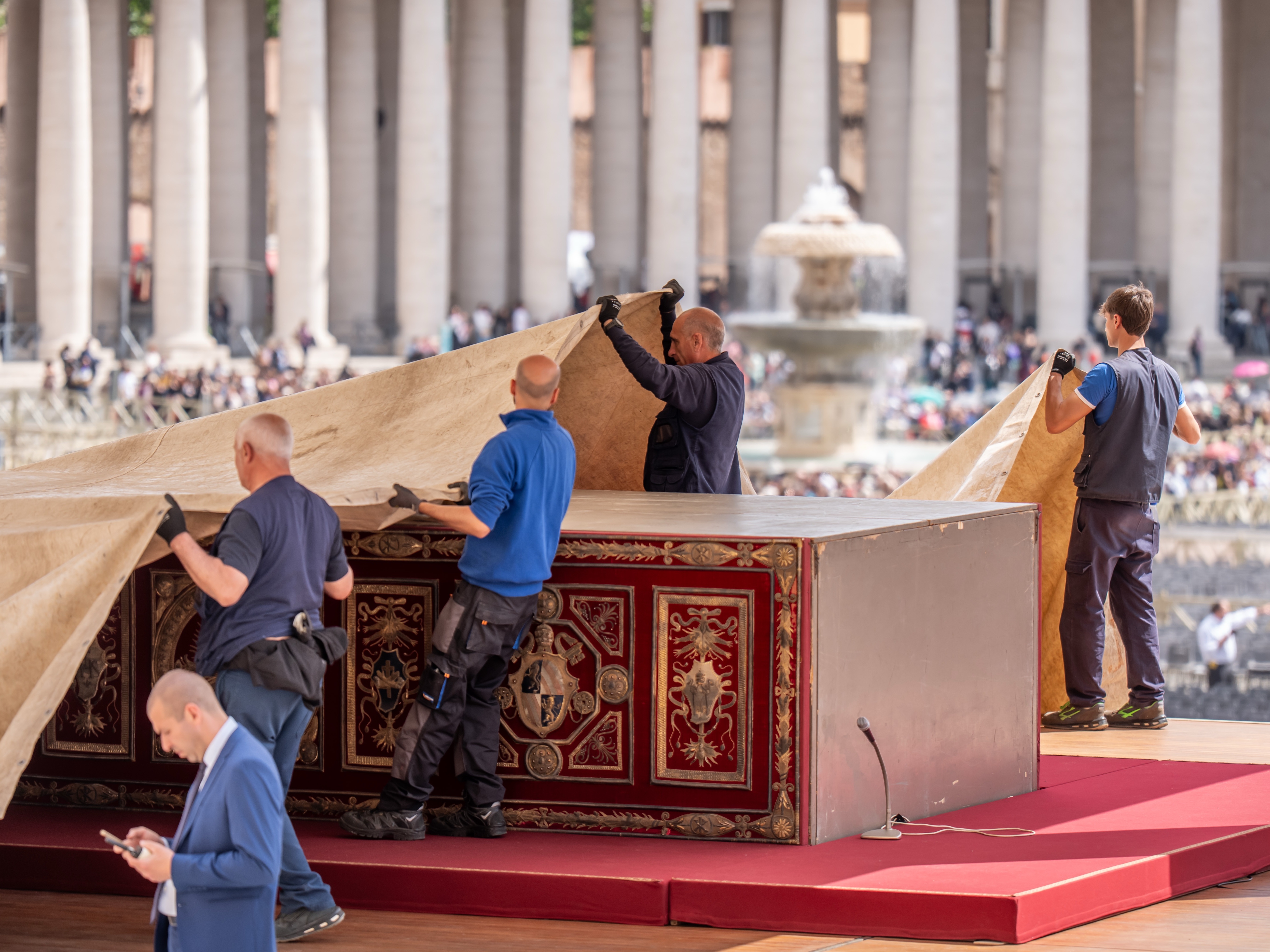 caption: Workers cover the altar in St. Peter's Square in preparation for Pope Francis's funeral on Saturday.