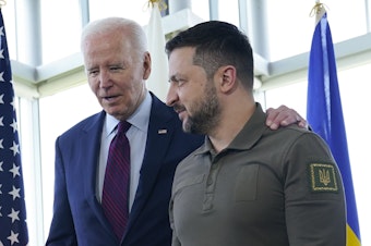 caption: President Biden walks with Ukrainian President Volodymyr Zelenskyy ahead of a working session on Ukraine during the Group of Seven summit in Hiroshima, Japan, Sunday. In a win for the Ukrainian leader, Biden supported training Ukraine's pilots to fly F-16s.