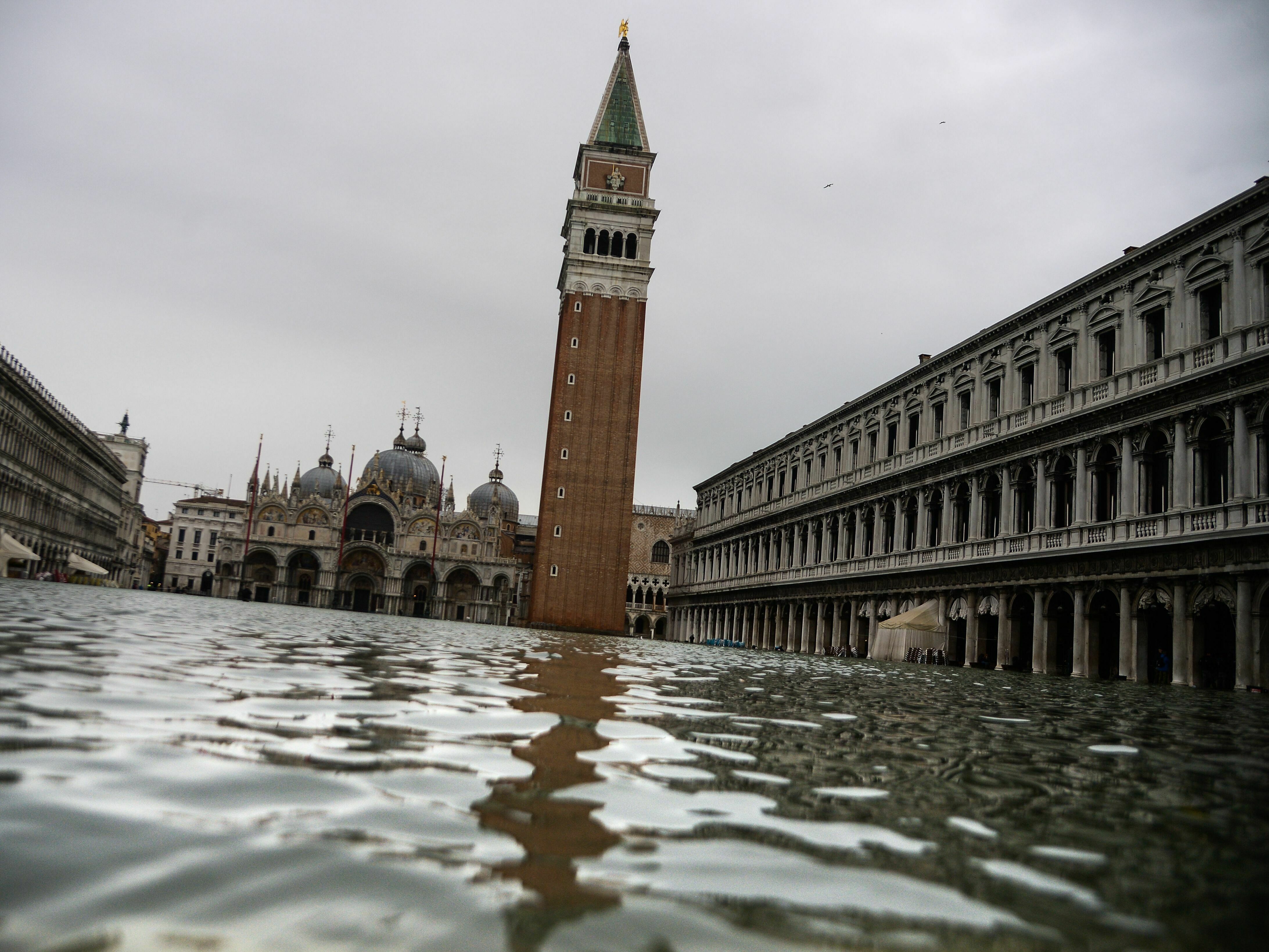 caption: The flooded St. Mark's Square on Nov. 15, 2019, in Venice, two days after the city suffered a high tide.