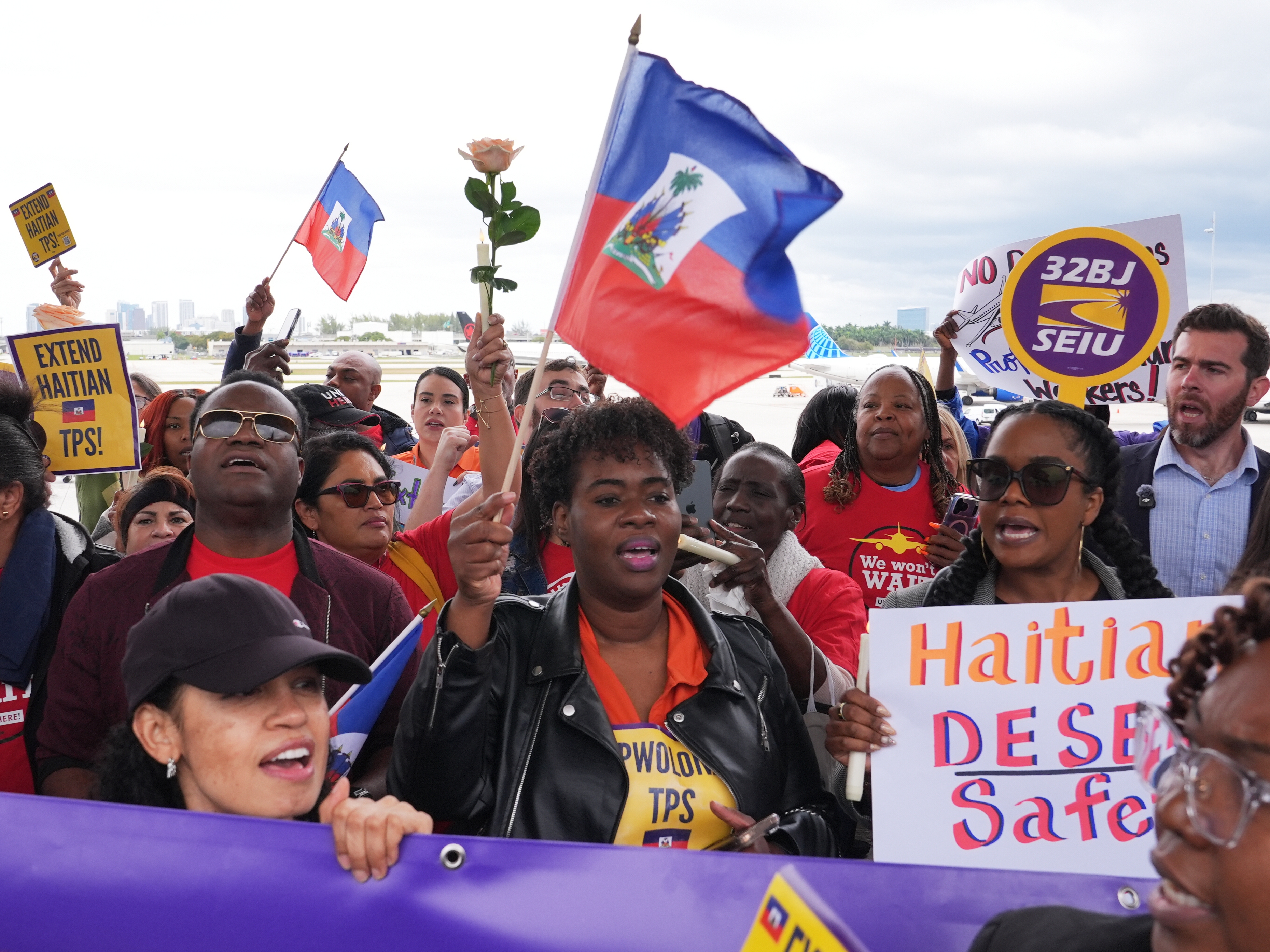 caption: People chant during a rally in Fort Lauderdale, Fla., in support of the extension of Temporary Protected Status (TPS) for Haitian immigrants.