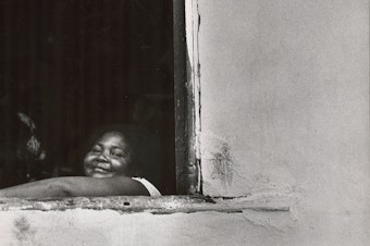 caption: Looking out of an adobe window. Salvador, Brazil, 1963.