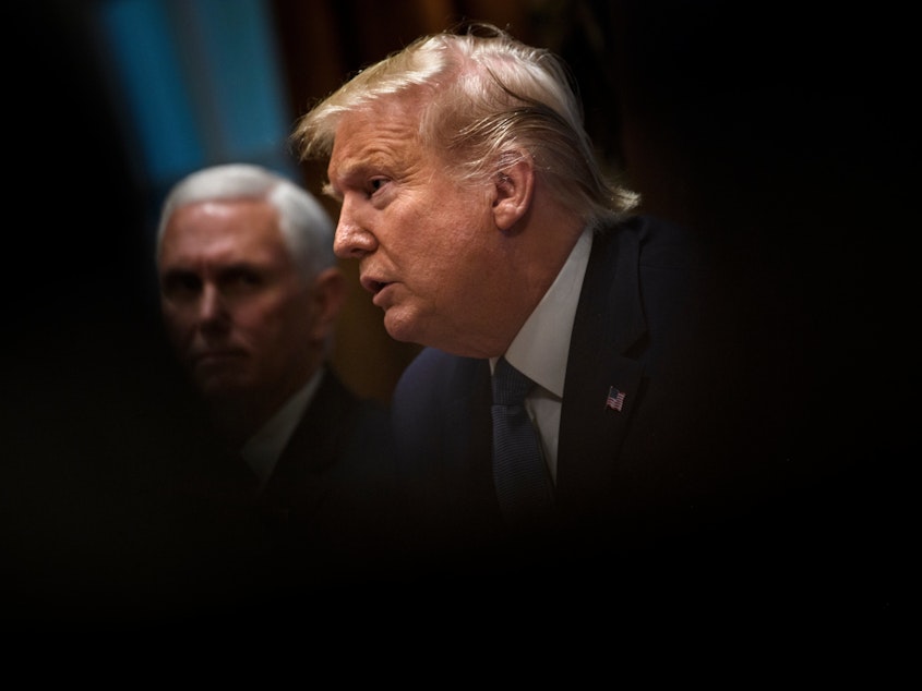 caption: President Trump addresses a Cabinet meeting last month at the White House, as Vice President Pence looks on in the background. On Friday, the Trump administration suggested some of California's federal funds could be in jeopardy over the state's requirement that insurers cover abortions.