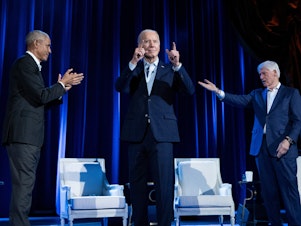 caption: Former President Barack Obama (left) and former President Bill Clinton (right) cheer for President Biden during a campaign fundraising event at Radio City Music Hall in New York City on March 28.