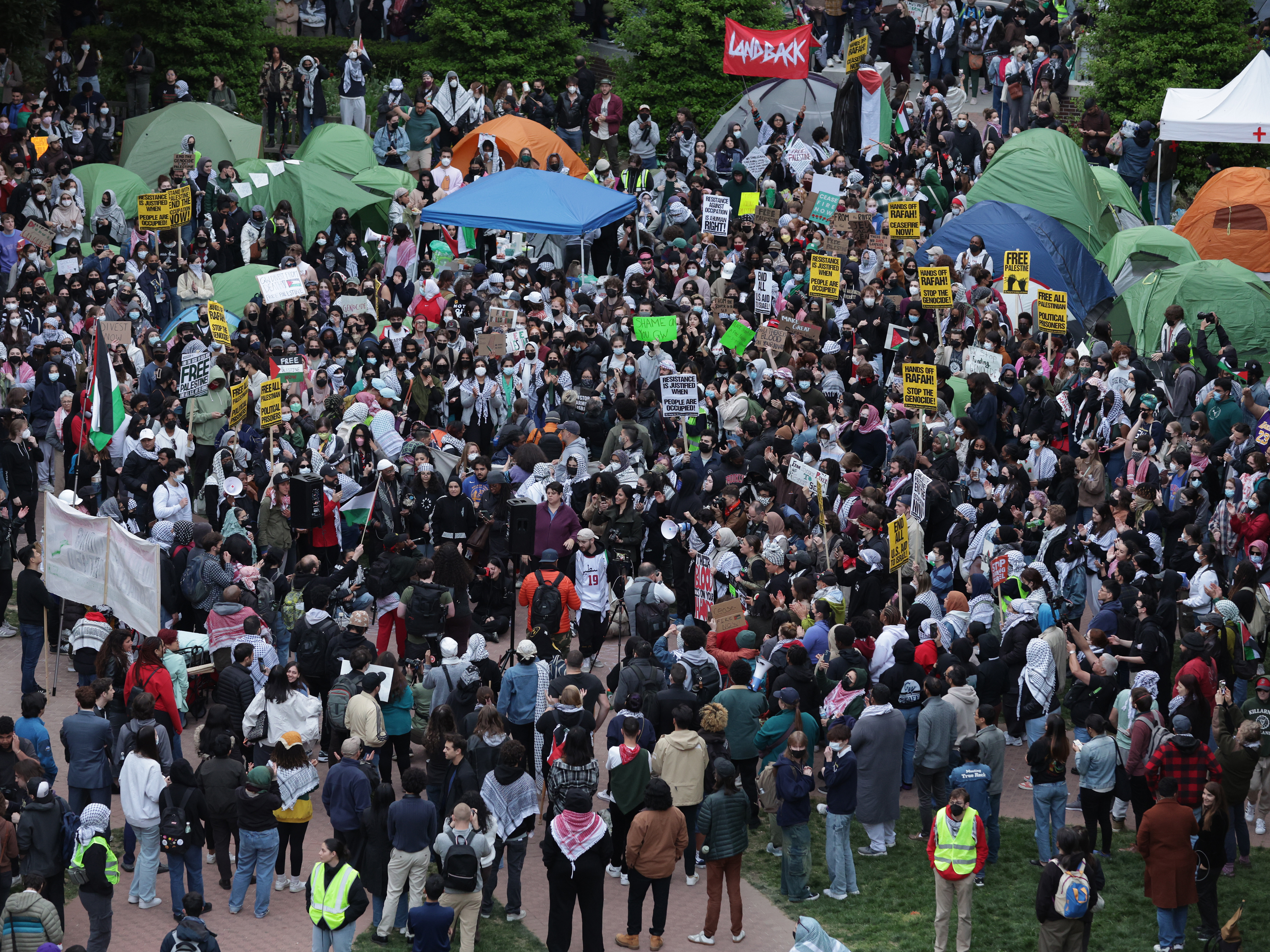 caption: Activists and students participate in an encampment protest at the University Yard at George Washington University on Thursday.
