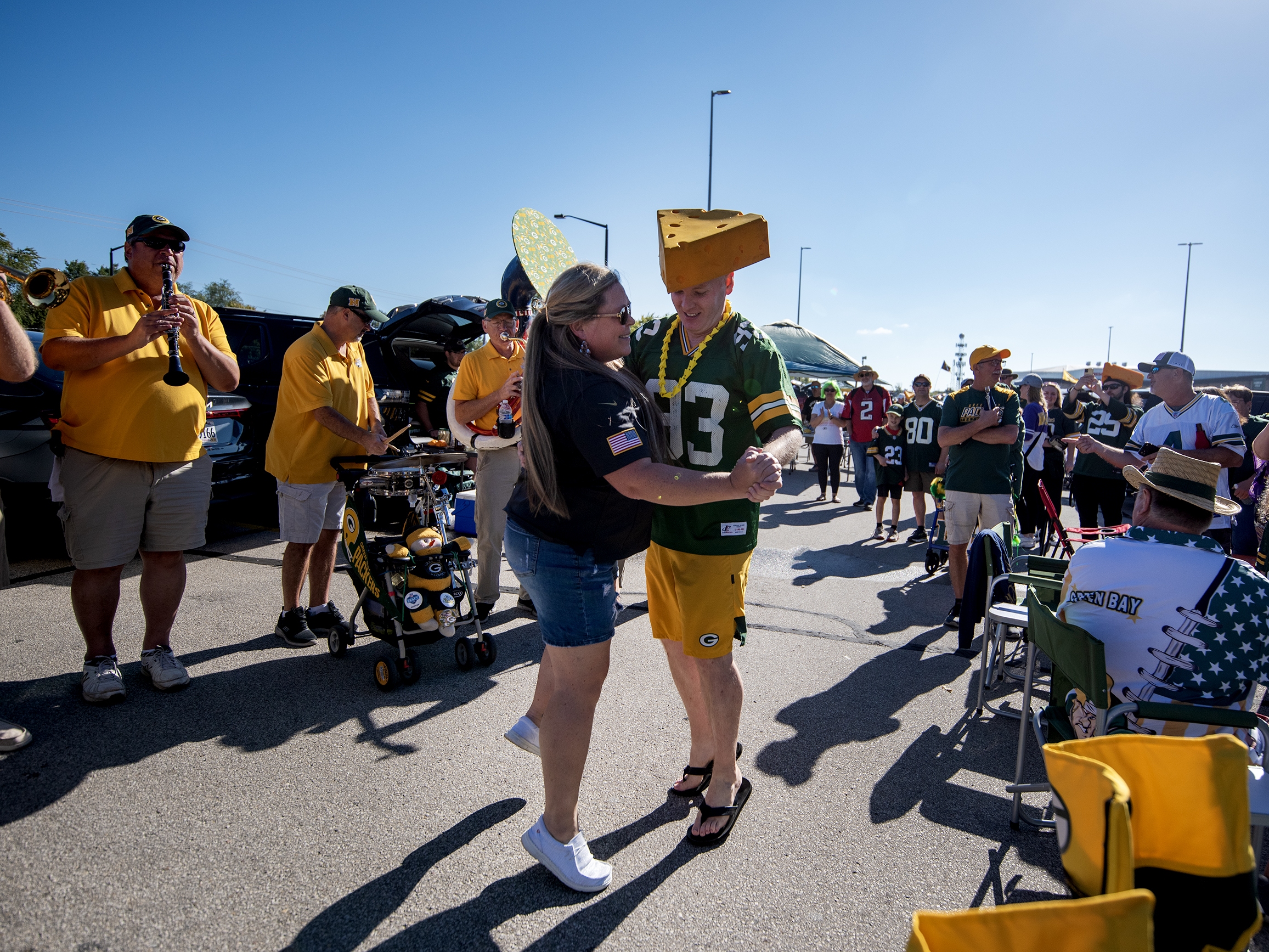caption: Packers fans Heather Gunnlaugsson, left, and Tim Mahoney, right, dance as the Packer Tailgate Band plays “Roll Out the Barrel” on Sunday, Sept. 29, before the Packers’ game against the Minnesota Vikings in Green Bay, Wis.