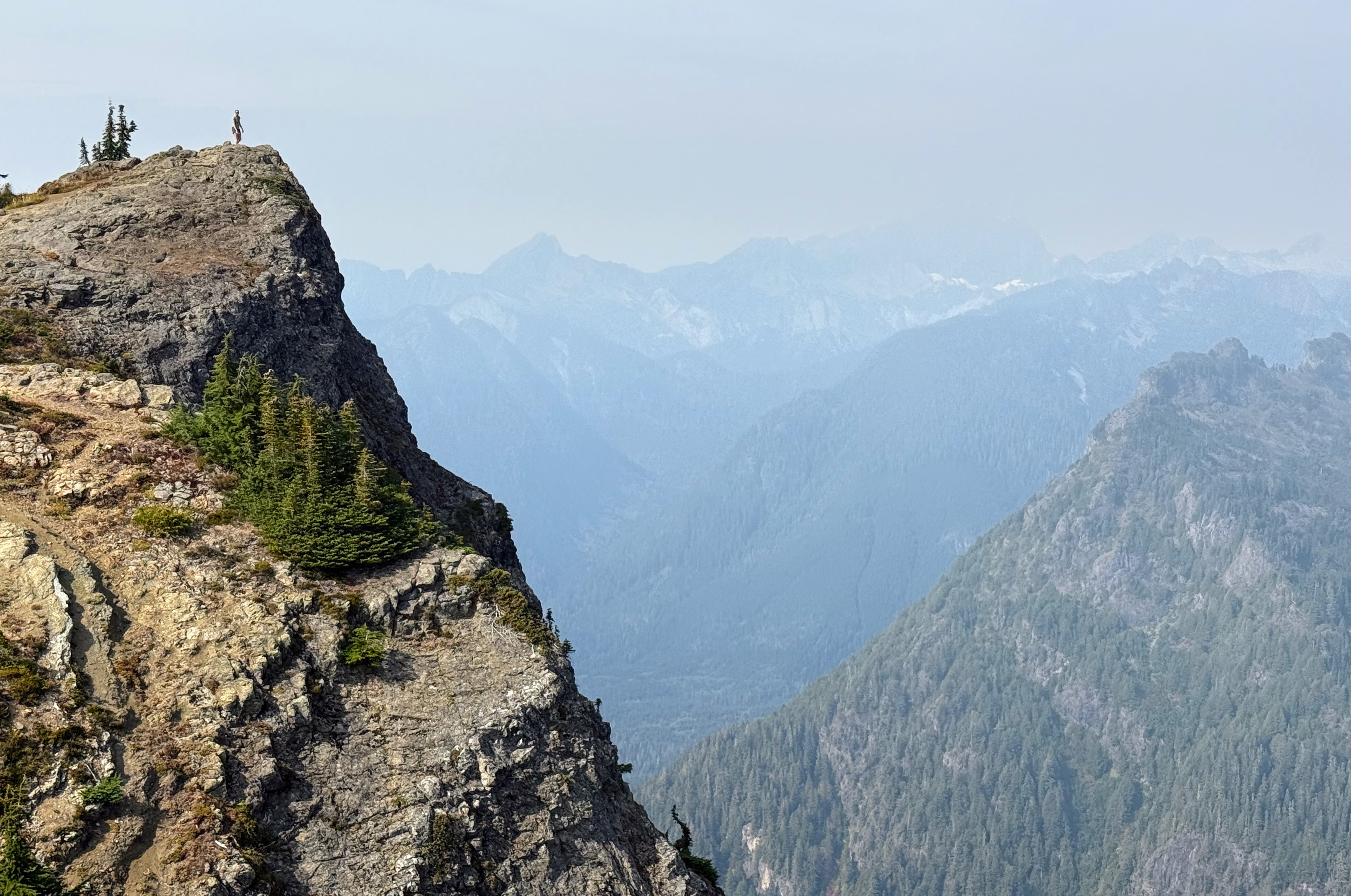 caption: Wildfire smoke hovers above Mount Dickerman and the Perry Creek Research Natural Area in the Mount Baker-Snoqualmie National Forest on Sept. 28, 2025.