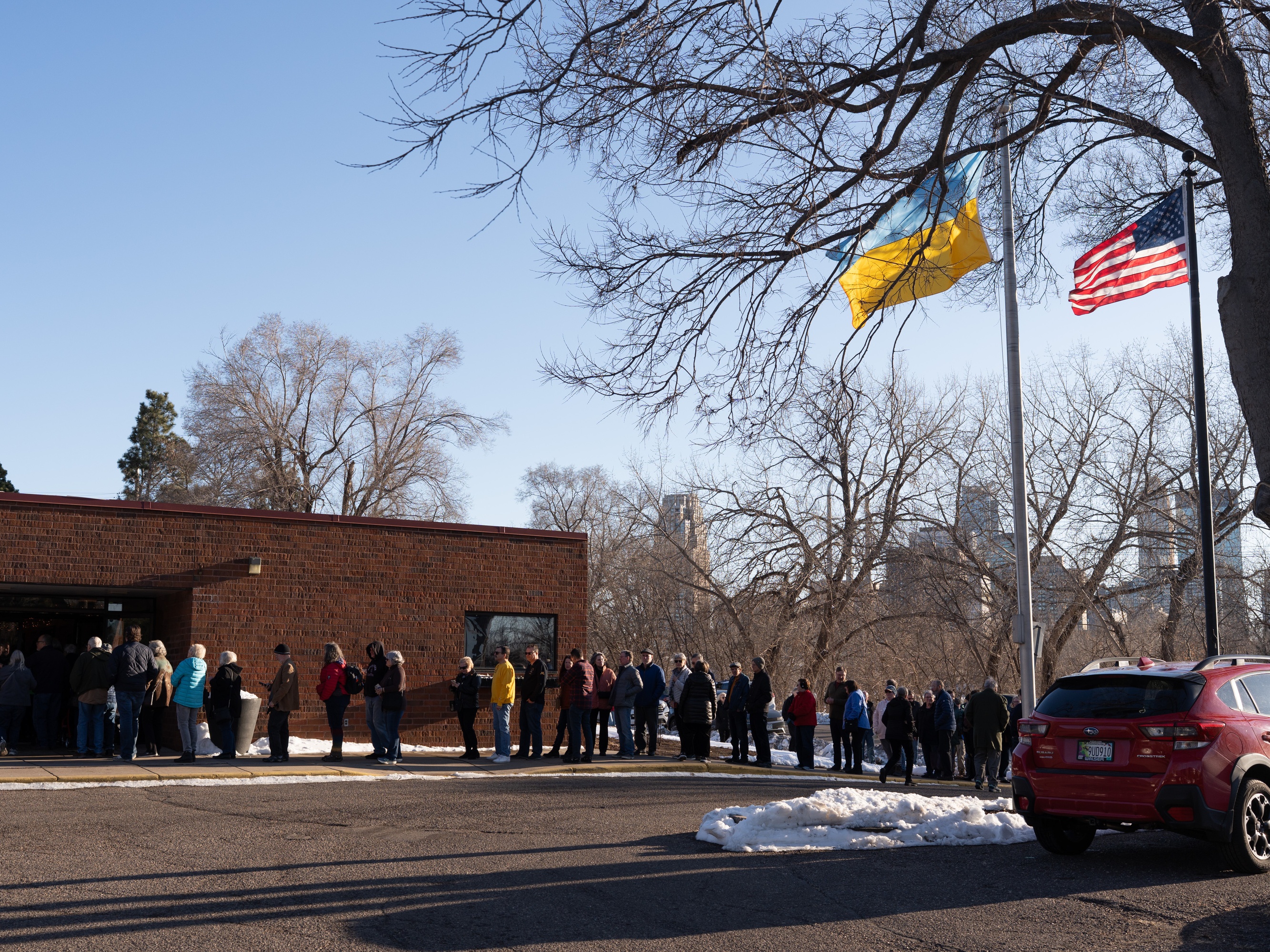 caption: People wait in line to attend a Lenten fish fry at the Ukrainian American Community Center in Minneapolis, MN, March 7, 2025. All tips from the event are used to provide humanitarian aid to Ukraine and support recently arrived Ukrainians.