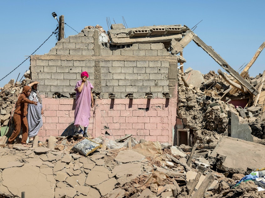 caption: Villagers inspect the rubble of collapsed houses in Tafeghaghte, southwest of Marrakesh, on Sept. 10.