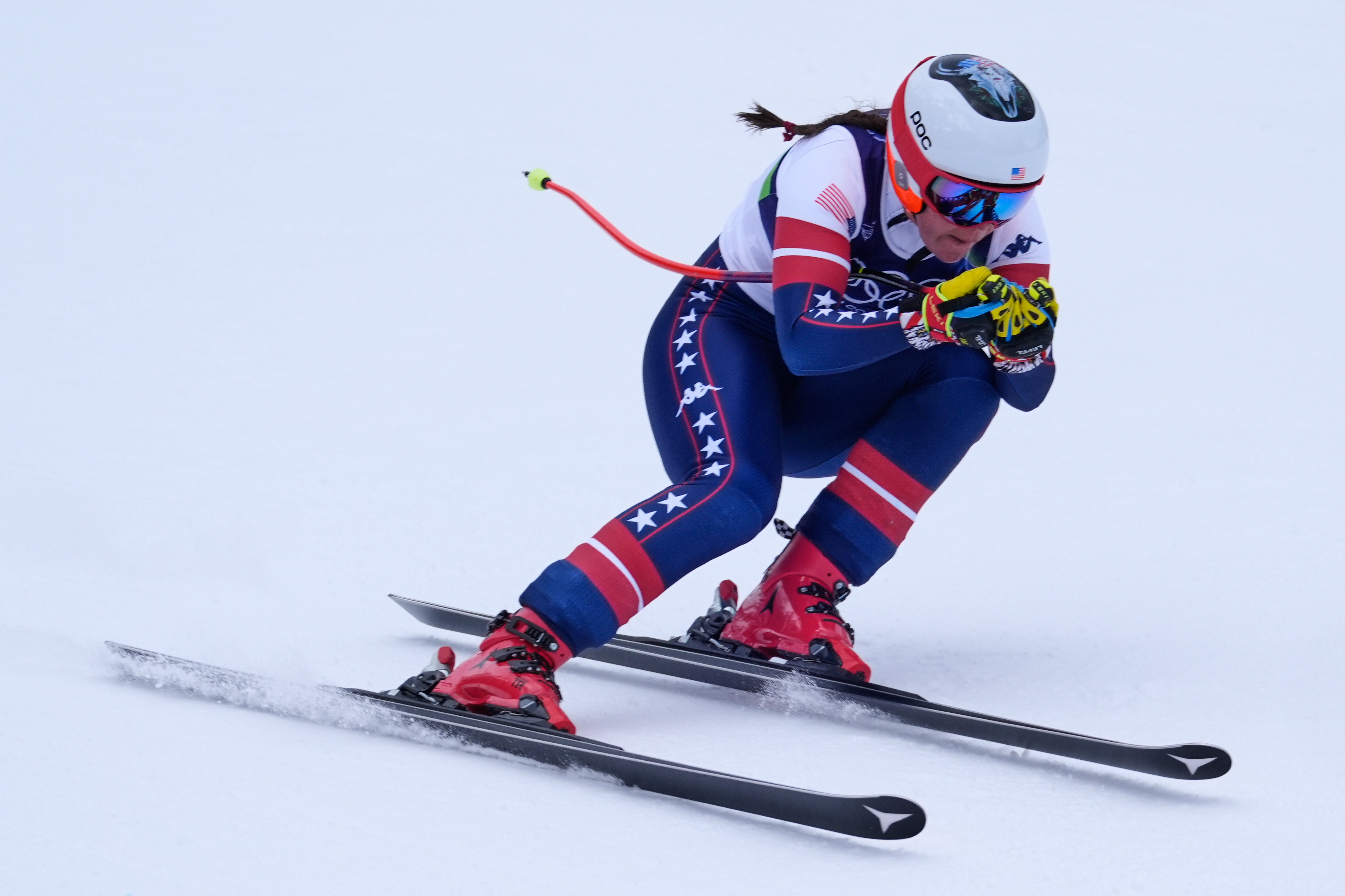 caption: United States' Breezy Johnson speeds down the course during an alpine ski, downhill portion of a women's team combined race, at the 2026 Winter Olympics, in Cortina d'Ampezzo, Italy, Tuesday, Feb. 10, 2026. 