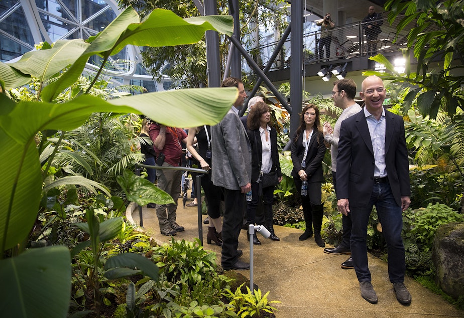 caption: Jeff Bezos laughs while touring The Spheres, which opened on Monday, January 29, 2018, in Seattle. Tap or click on the first image to see more.