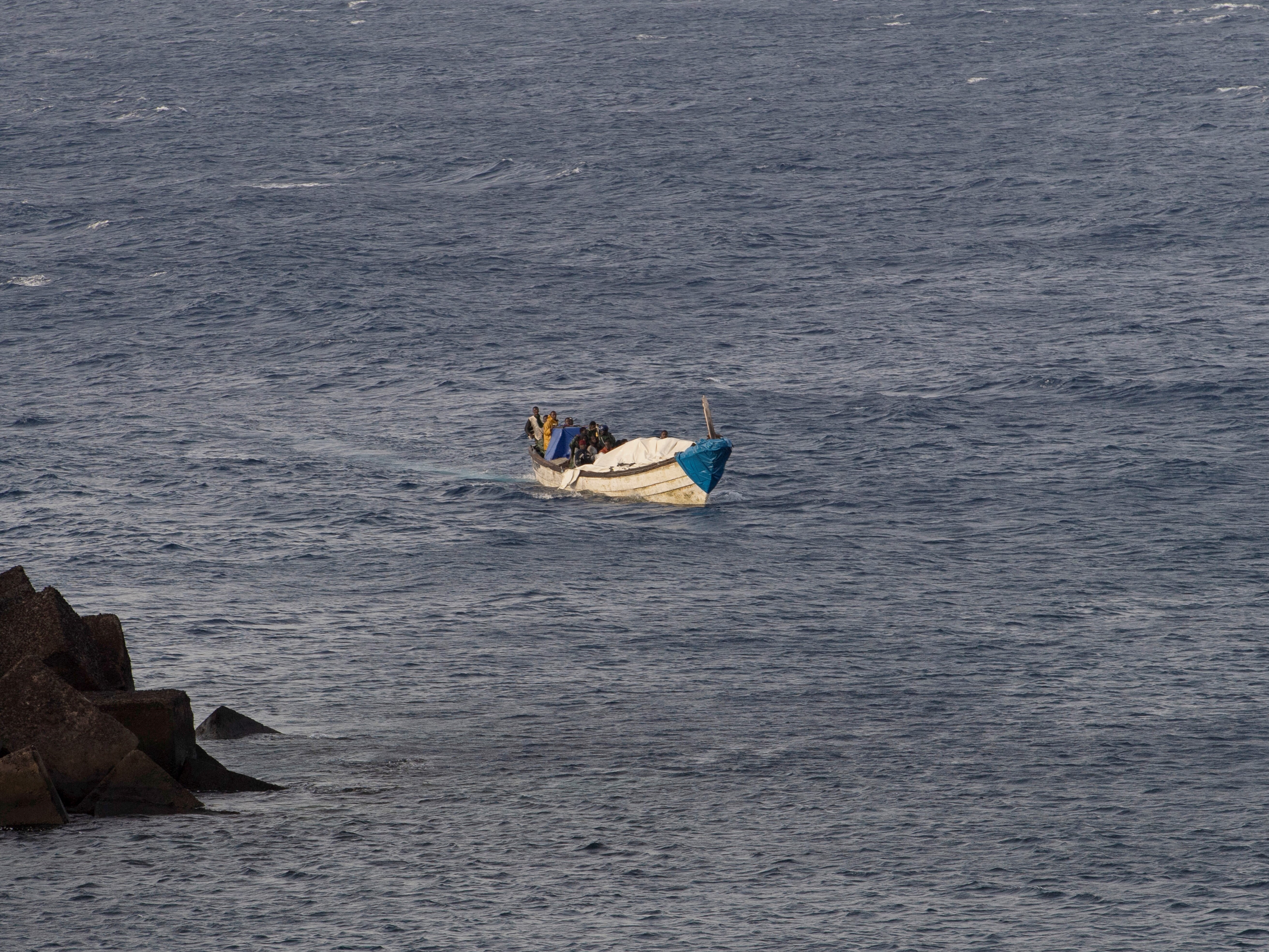 caption: A boat with 57 migrants onboard arrives at La Restinga port on the Canary island of El Hierro, on September 14, 2024.