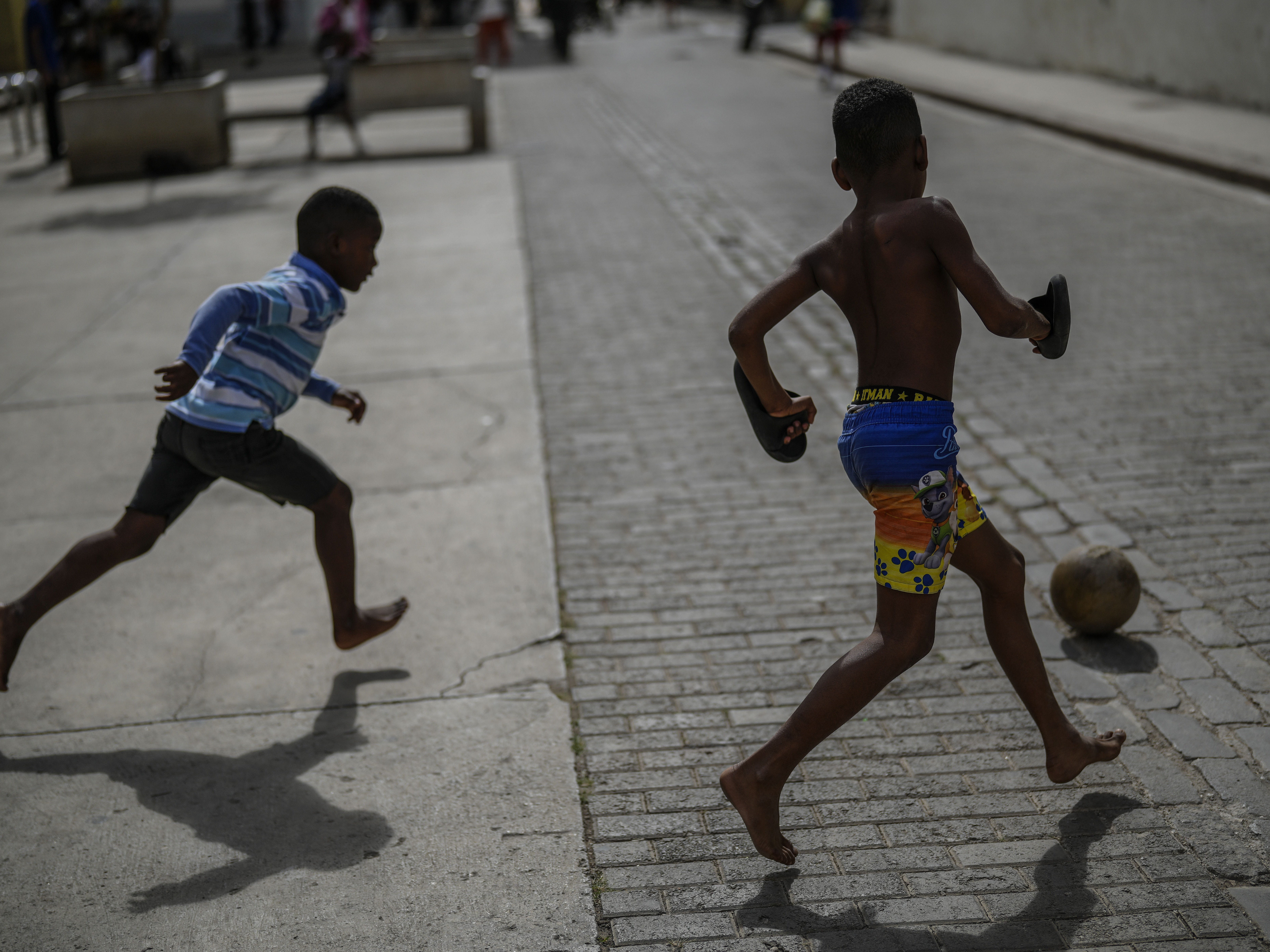 caption: Children kick a ball around during a power outage in Havana, Cuba, on Wednesday.