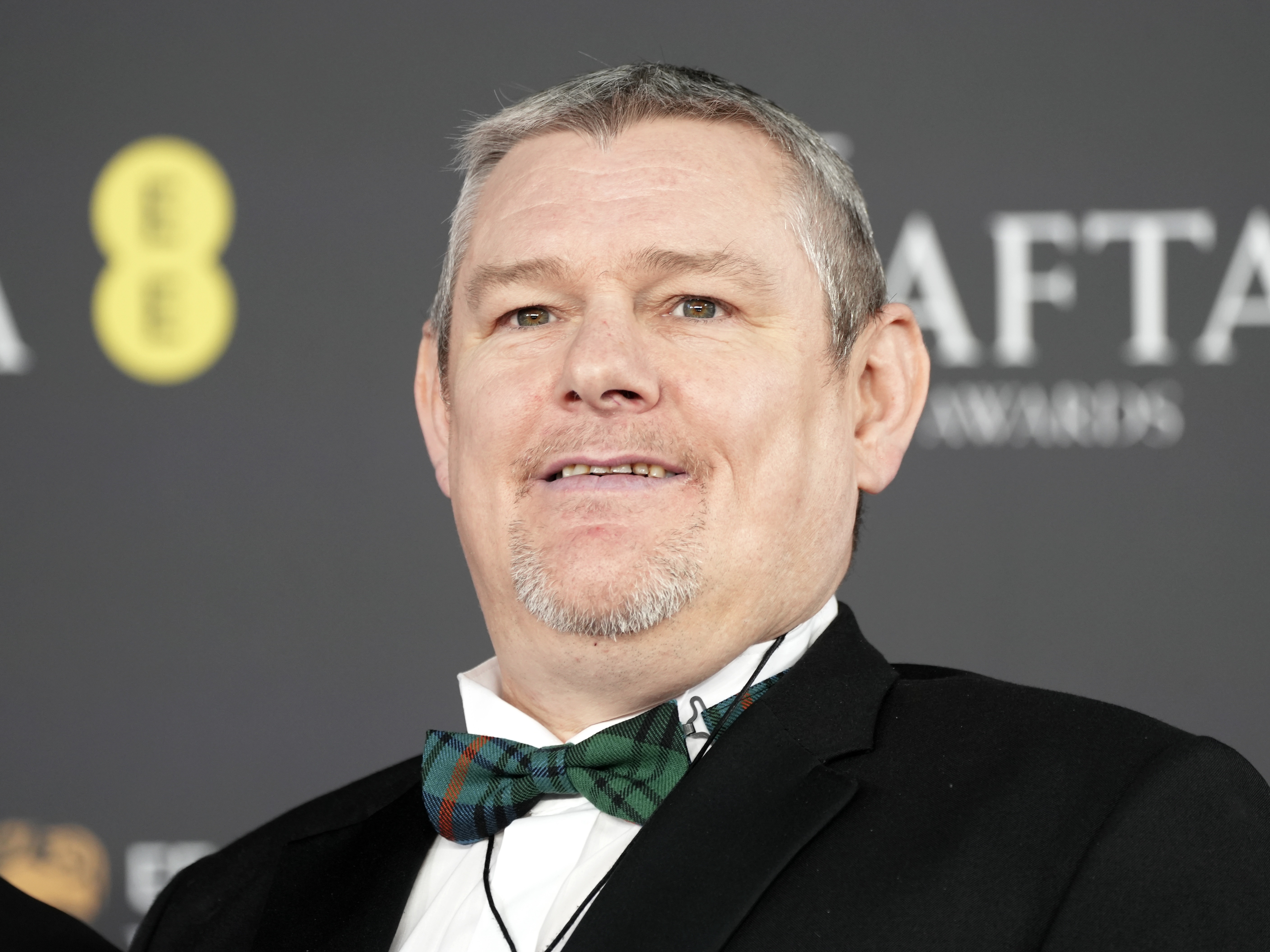 caption: John Davidson attends the 2026 BAFTA Film Awards on February 22, 2026 in London, England.