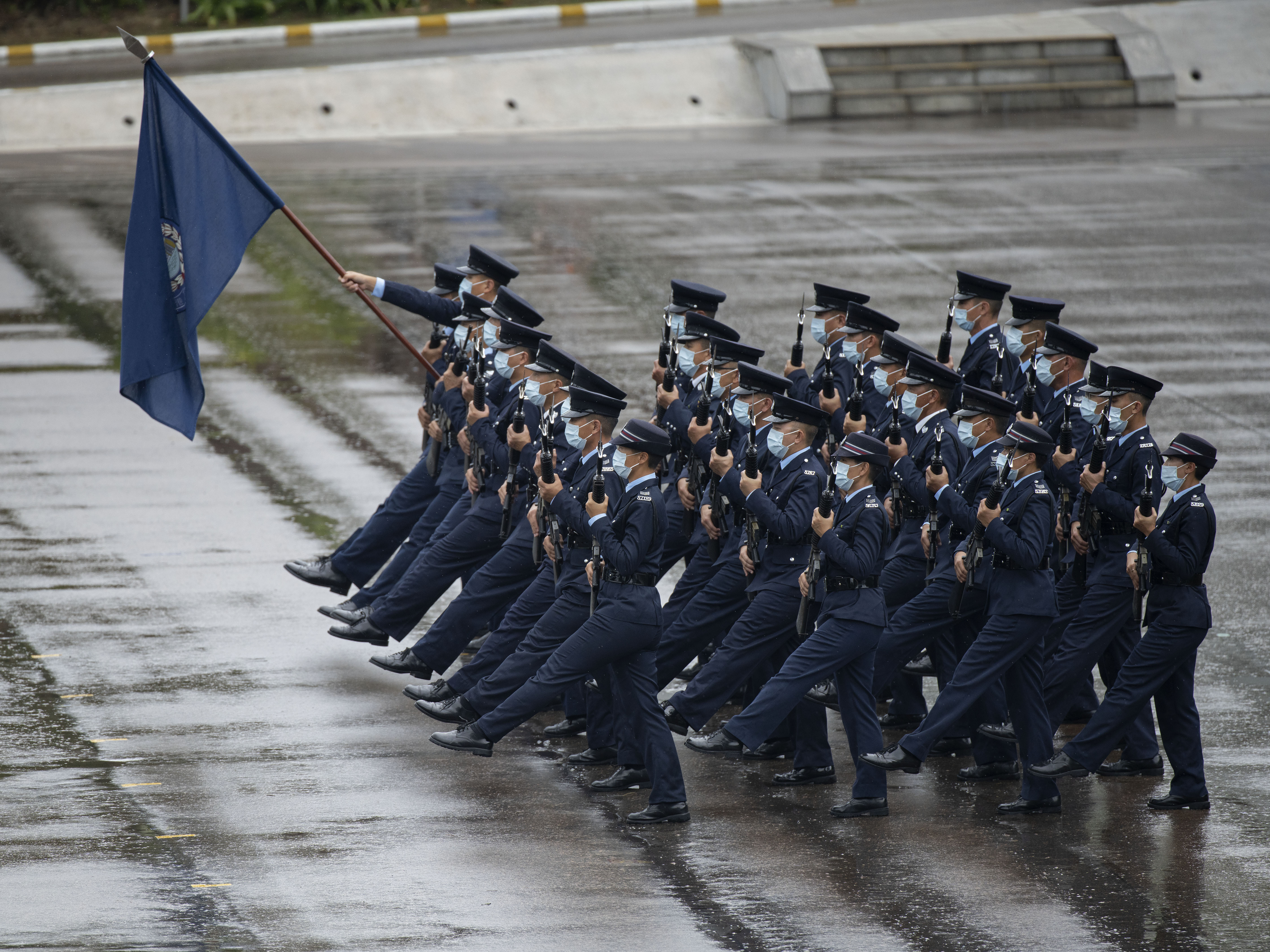 caption: Hong Kong police show their new goose step marching style on National Security Education Day at a police school in Hong Kong on April 15.