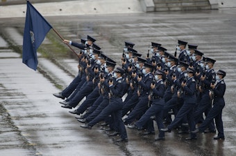 caption: Hong Kong police show their new goose step marching style on National Security Education Day at a police school in Hong Kong on April 15.