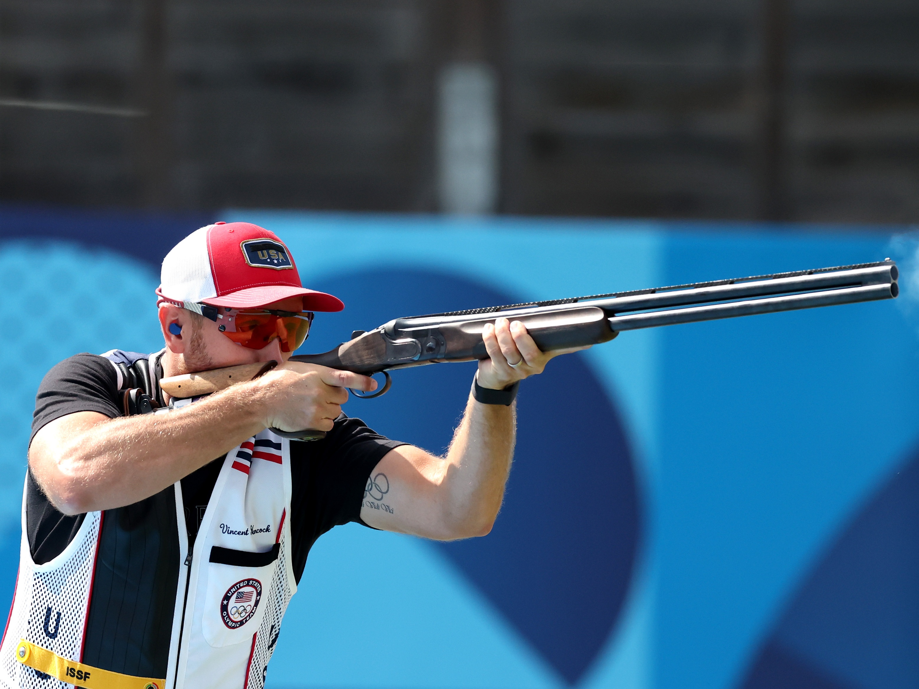 caption: American Vincent Hancock competes in the Shooting Skeet Men's Final Saturday at Chateauroux Shooting Center in Chateauroux, France.