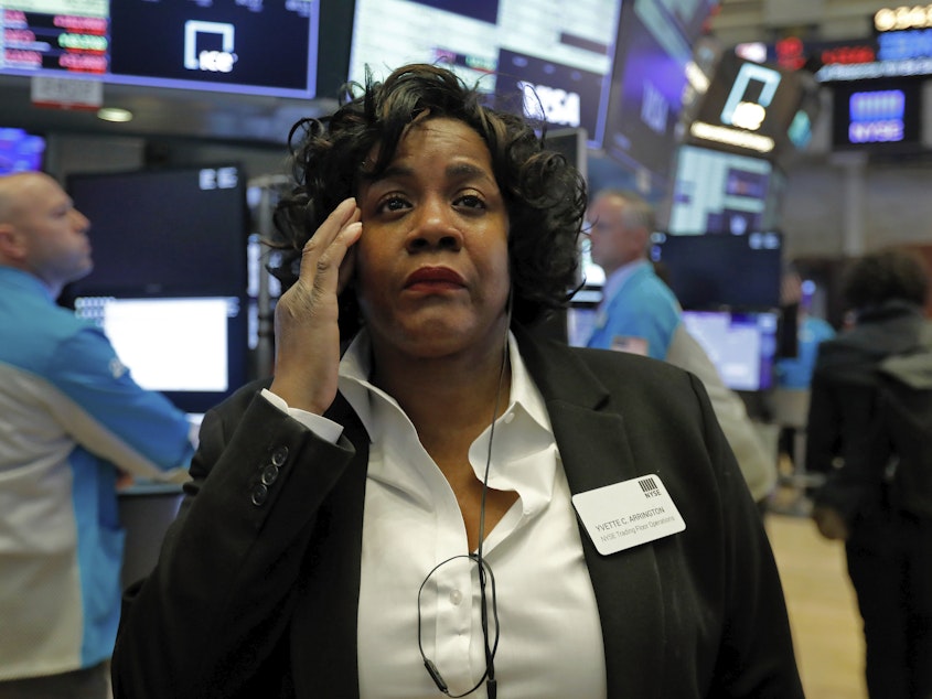 caption: Yvette Arrington with the New York Stock Exchange trading floor operations watches the market slide on March 9 as coronavirus fears grip the financial markets.