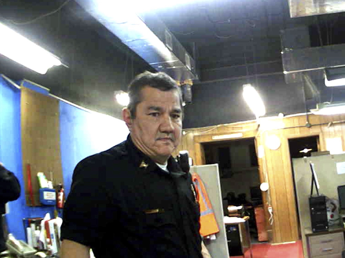 caption: This image from Marion, Kan., Police Department body camera video provided by the McDonald Tinker law firm shows former Marion Police Chief Gideon Cody during his department's raid of the Marion County Record newspaper on Aug. 11, 2023, in Marion, Kan.