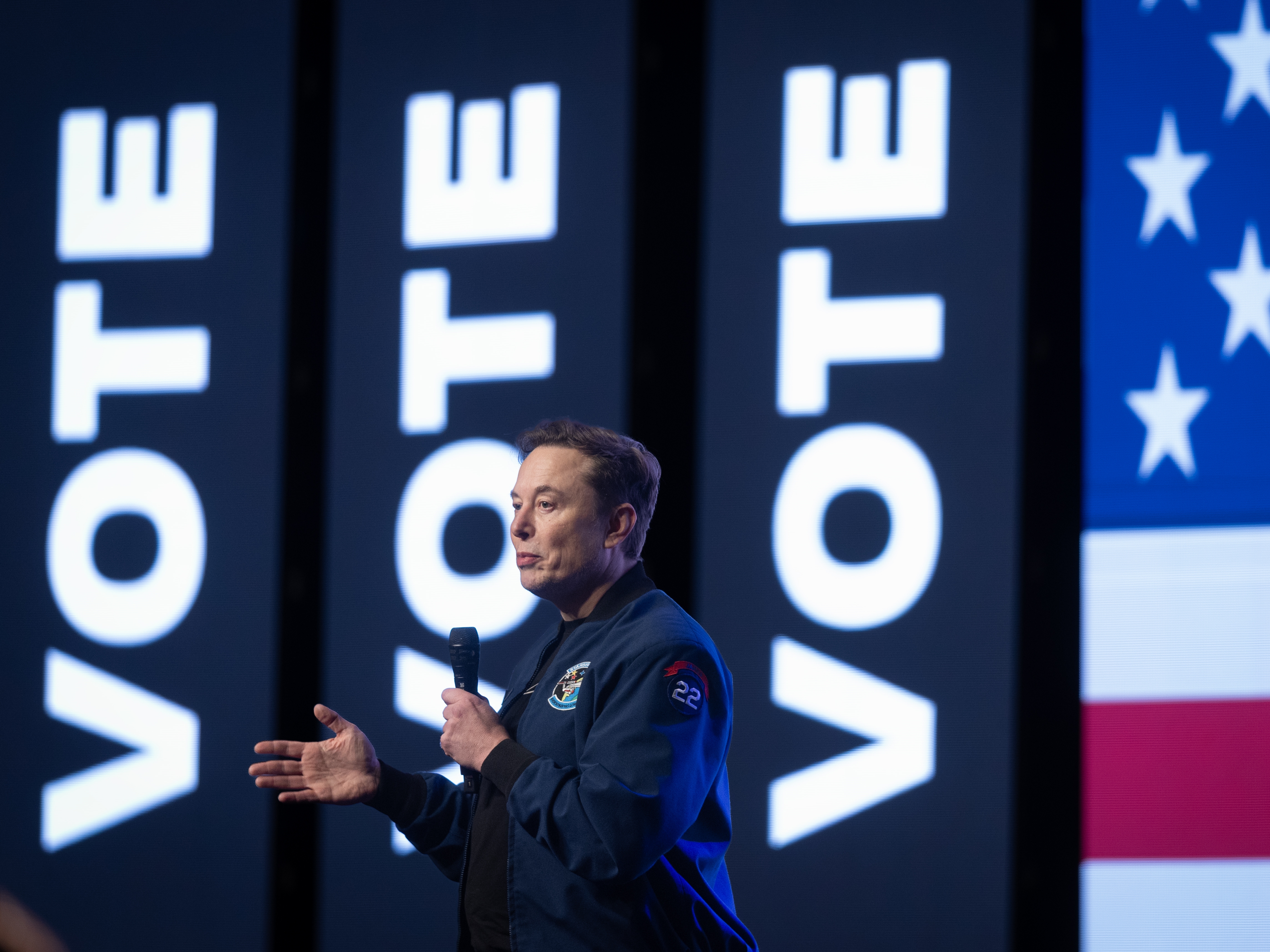 caption: Elon Musk speaking during a town hall meeting on March 30, 2025 in Green Bay, Wisc. ahead of a state Supreme Court election where he invested millions of dollars, only to see his preferred candidate lose. The billionaire announced on Tuesday that he planned to spend less on politics going forward.