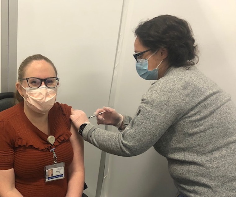 caption: Emily Fay received her first dose of the COVID vaccine on December 24.