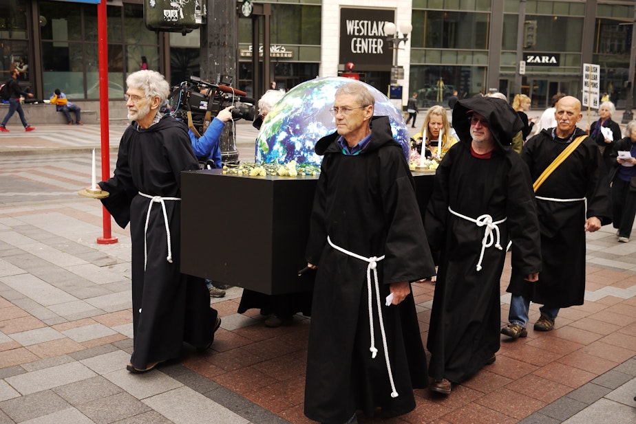 caption: A symbolic funeral for Earth Day in downtown Seattle.