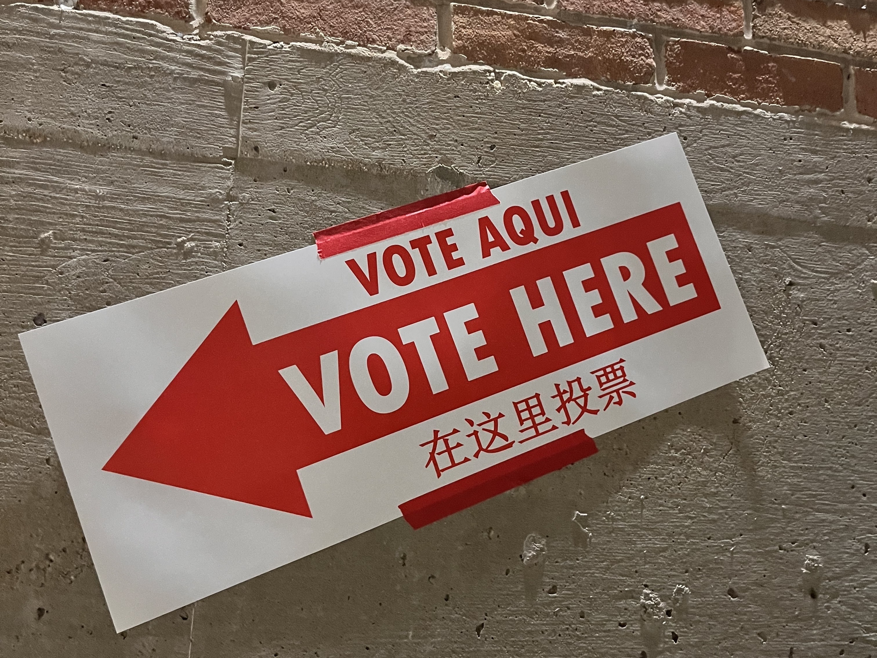 caption: A "vote here" sign in Washington, D.C.