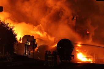 caption: United States safety regulators have adopted an emergency order requiring tests of crude oil before shipment by rail. The move is in response to a string of explosions and fires, like this one in Quebec, which claimed 47 lives.