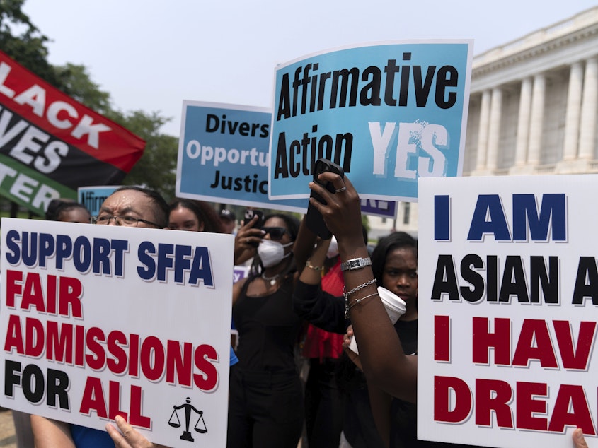caption: Demonstrators protest outside of the Supreme Court in Washington, Thursday, June 29, 2023, after the Supreme Court struck down affirmative action in college admissions, saying race cannot be a factor.