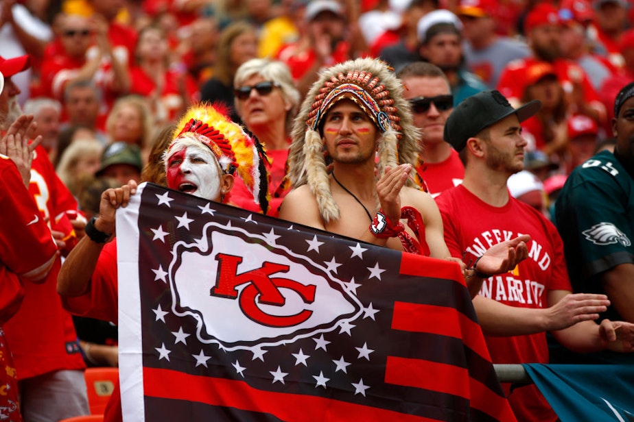 caption: Native American communities and allies are speaking out against the NFL’s decision to allow Kansas City Chiefs fans to attend the Super Bowl wearing mock headdresses, face paint and performing the so-called “tomahawk chop” chant. (Jamie Squire/Getty Images)