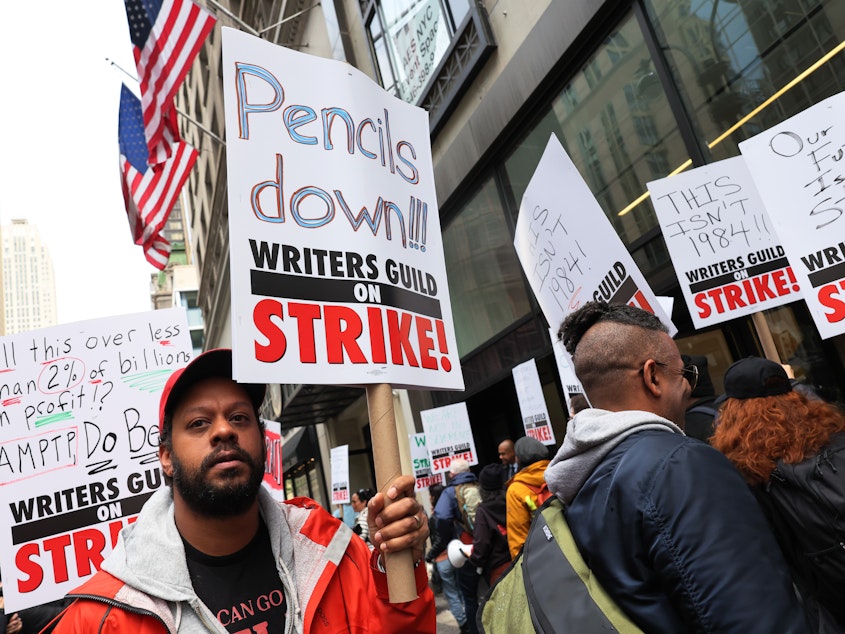 caption: Members of the Writers Guild of America (WGA) East picketed outside of the Peacock NewFront on May 2, 2023 in New York City as the WGA strike began.