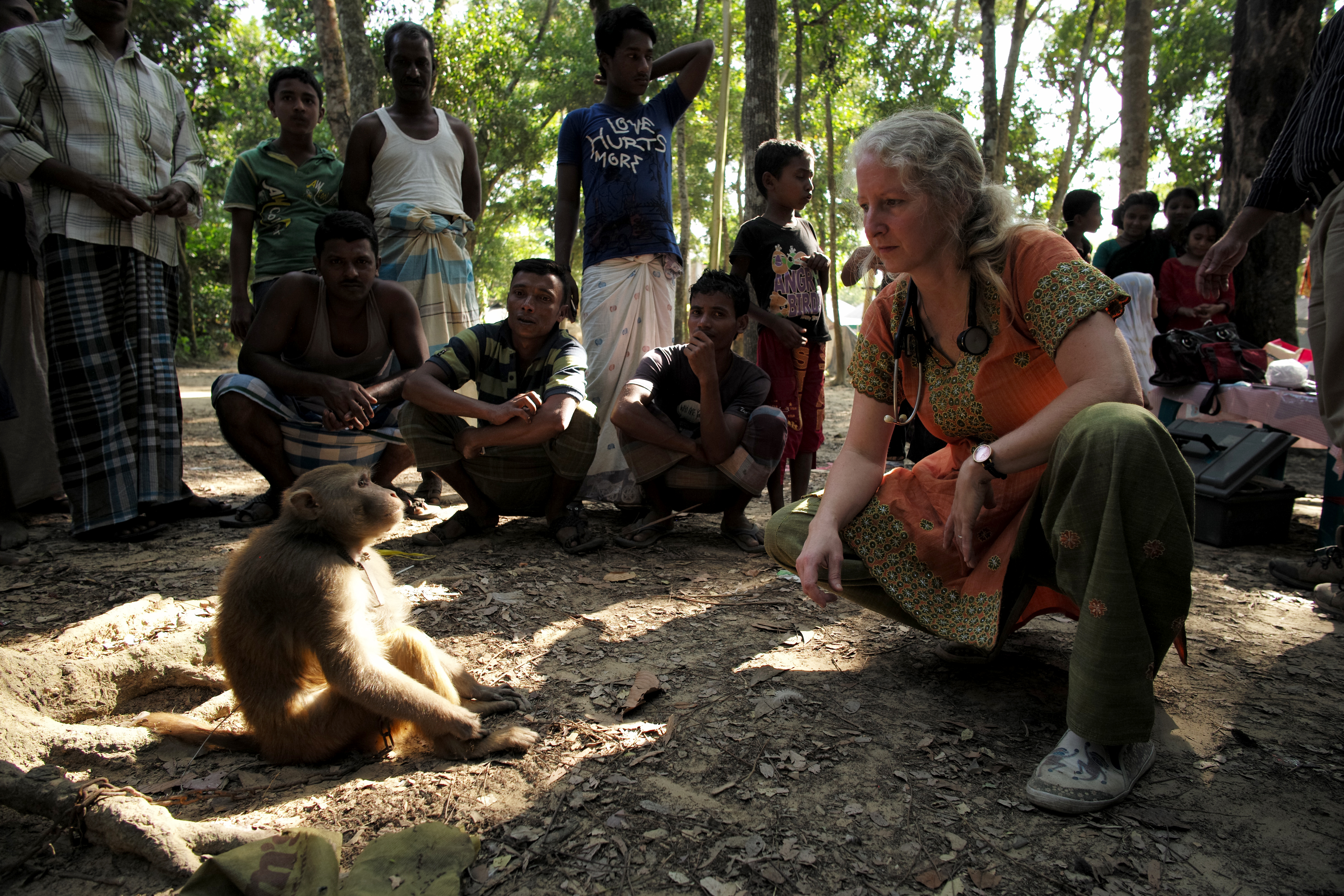 caption: Dr. Lisa Jones-Engel, a primate scientist, and a rhesus macaque in Bangladesh in 2015, not long before she stopped working at the UW's National Primate Research Center.