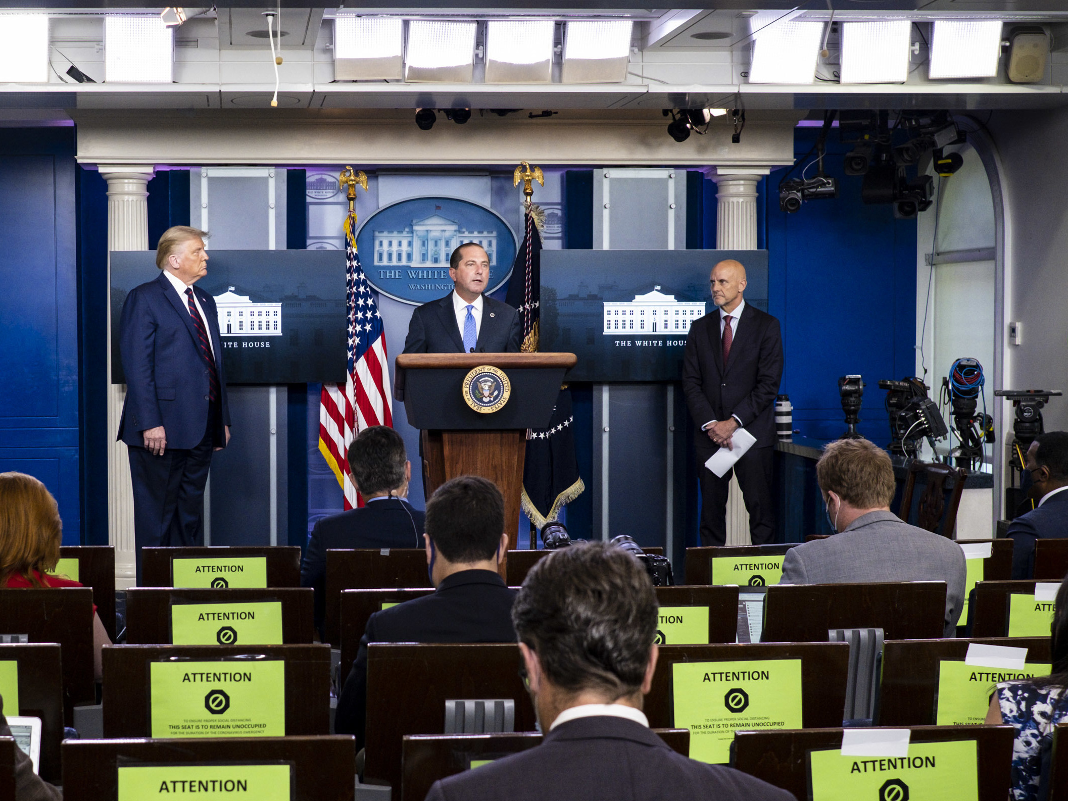 caption: President Donald Trump, left, FDA Commissioner Stephen Hahn, right, and Health and Human Services Secretary Alex Azar, center, announced at a news conference on Sunday that the FDA issued emergency use authorization for convalescent plasma as a COVID-19 treatment.