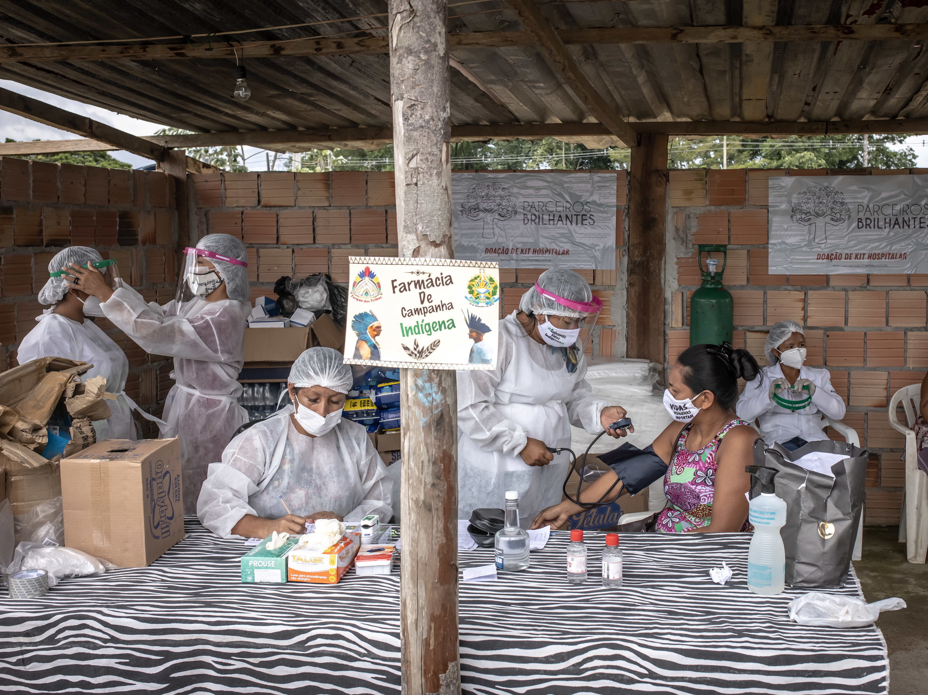 caption: Indigenous health care workers treat patients last week at a campaign hospital set up in the Parque das Tribos neighborhood of Manaus, Brazil. Oxygen shortages at hospitals in Brazil's Amazon prompted authorities to airlift patients to other states.