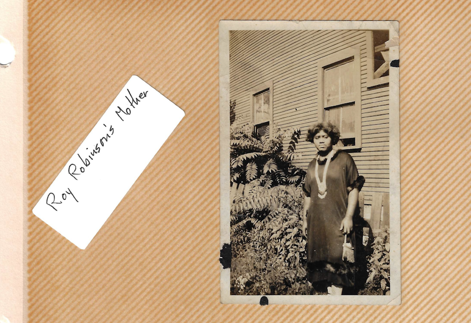 caption: Rosie Short Robinson, the matriarch of Indigo May's family, standing in front of her house. Year and location unknown.
