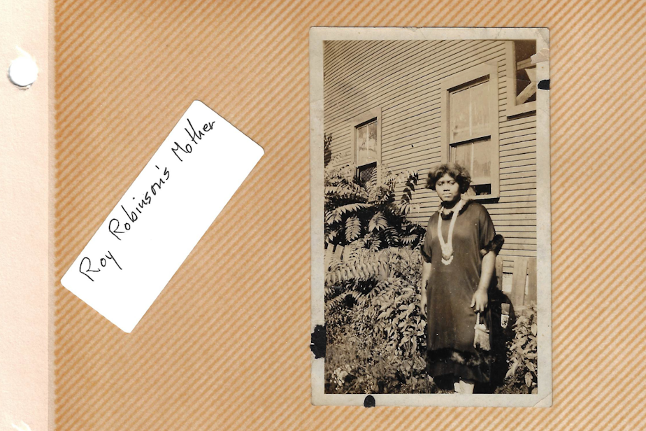 caption: Rosie Short Robinson, the matriarch of Indigo May's family, standing in front of her house. Year and location unknown.