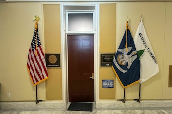 caption: "An Appeal to Heaven" flag, a symbol embraced in recent years by Christian Nationalists, hangs outside Speaker Mike Johnson's congressional office.