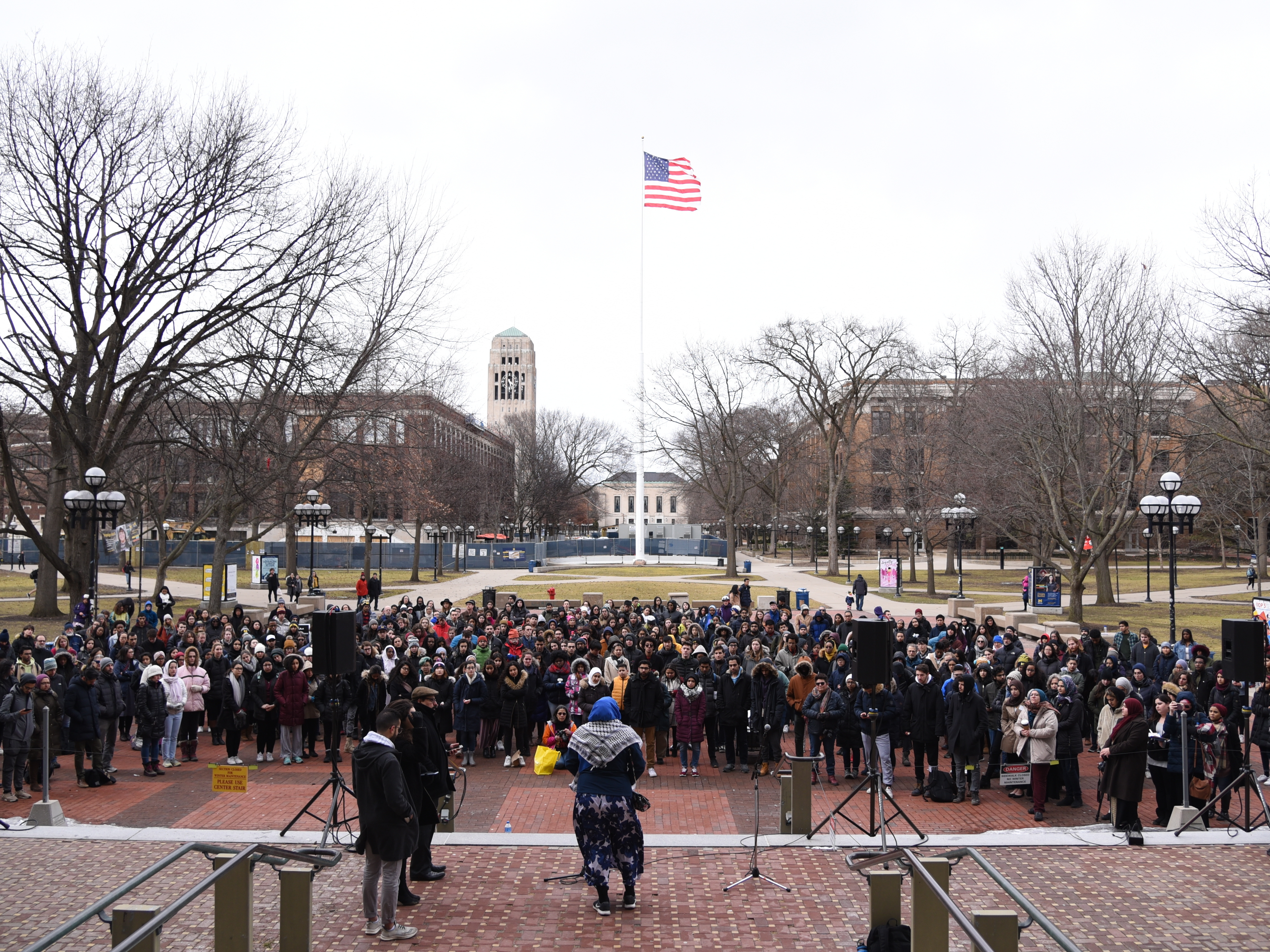 caption: An interfaith vigil, offering prayers and support for the Muslim community, begins at the University of Michigan in Ann Arbor, Mich., on Saturday evening.
