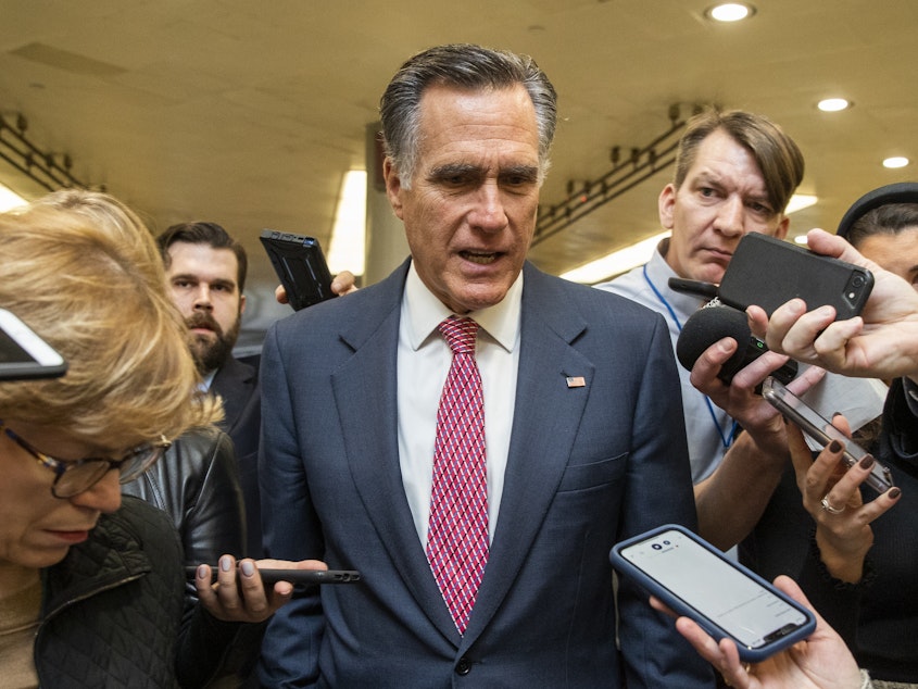 caption: Sen. Mitt Romney, R-Utah, speaks to reporters as he arrives at the Capitol. He became the first Senator to vote to convict and remove a U.S. President of the same party on Wednesday.